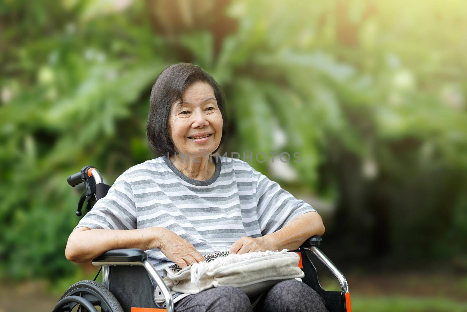 smiling elderly woman ,sitting on wheelchair