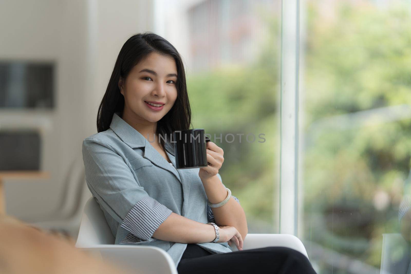 Portrait of Asian Business woman with coffee at morning at home. Account and Finance concept