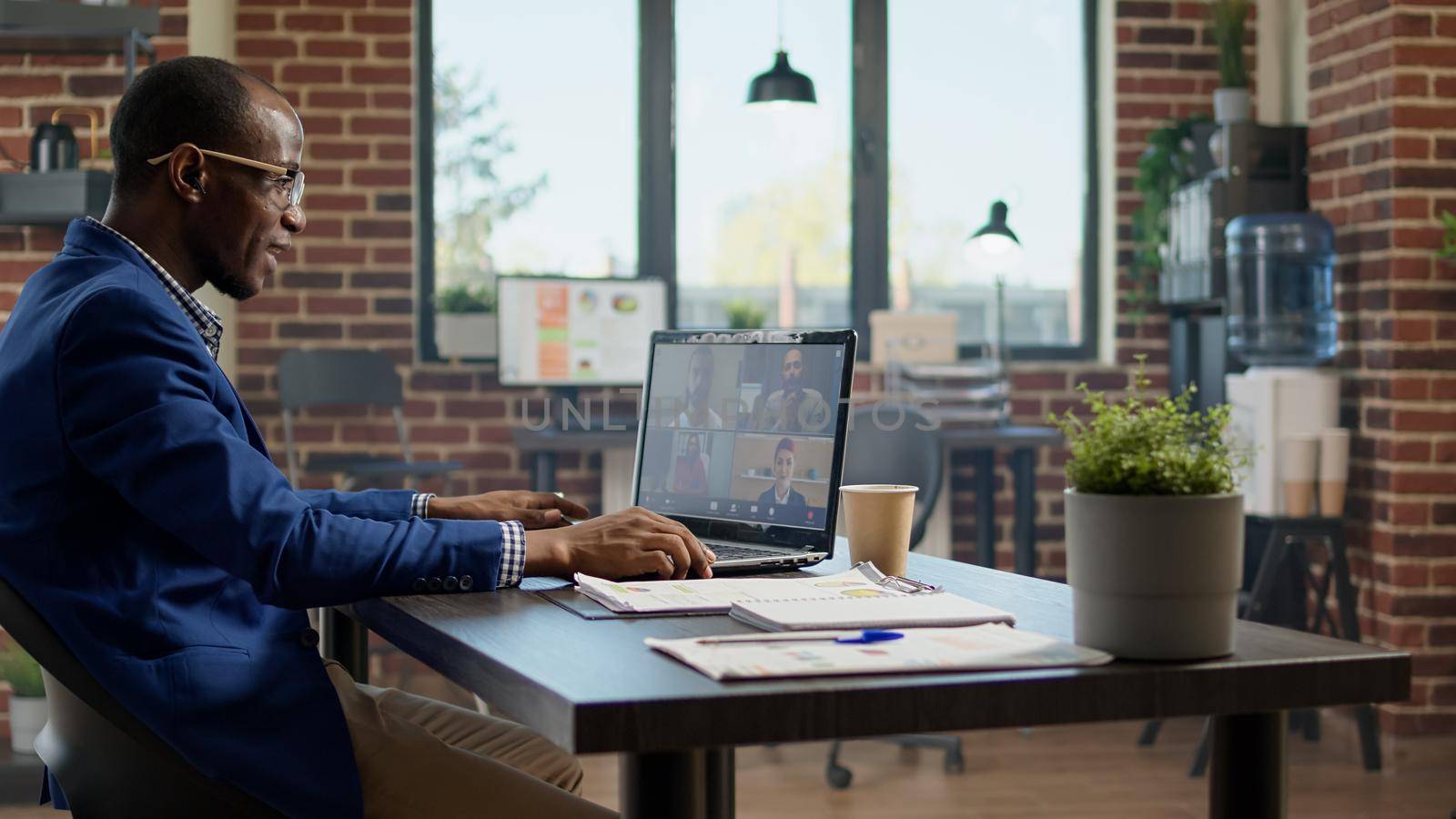 Company employee talking to colleagues on videocall conference, using remote teleconference for communication on laptop. Attending online business videoconference meeting, telework app.