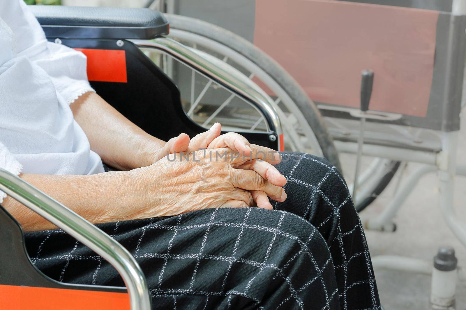 Elderly woman hand while waiting on wheelchair by toa55