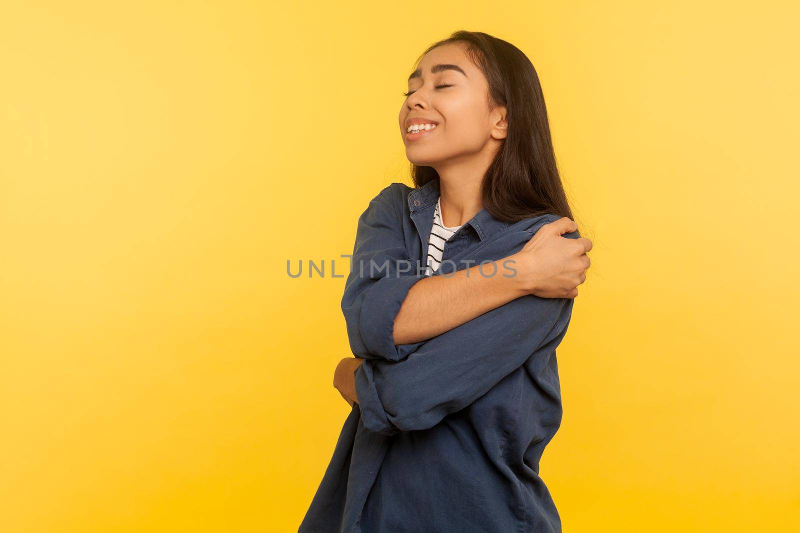 Portrait of young asian woman on yellow background. by Khosro1