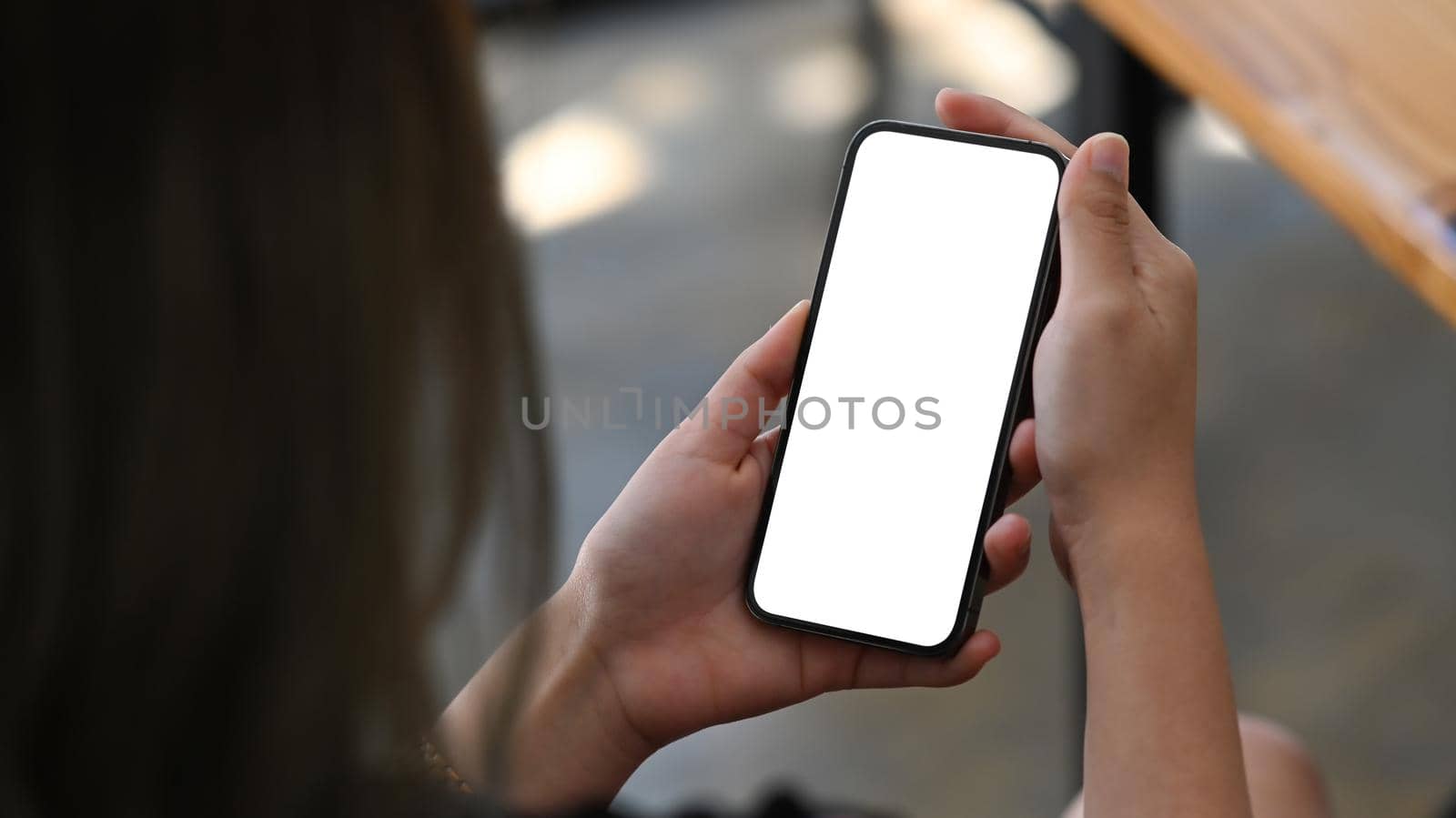 Woman hands holding smart phone with white empty screen for advertise.