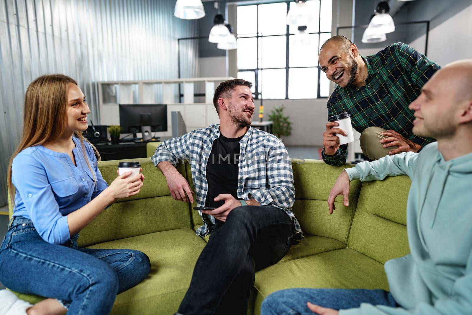 Young businesspeople talking during their office coffee break, close up