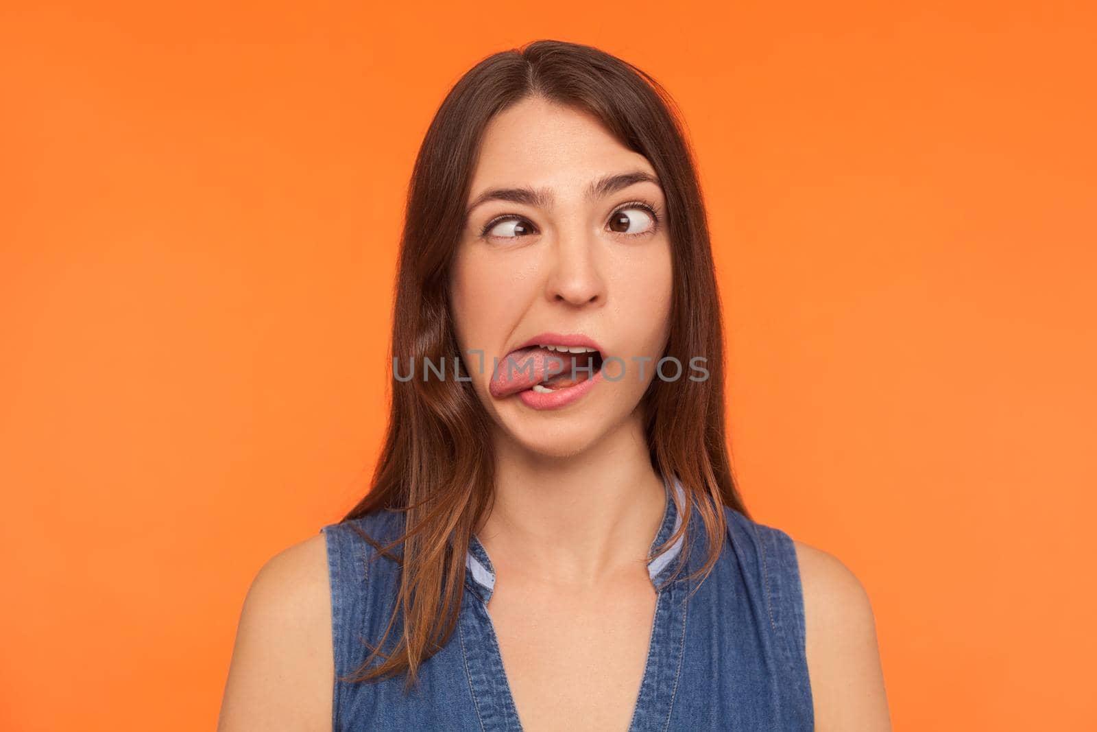 Portrait of young emotional woman on orange background. by Khosro1