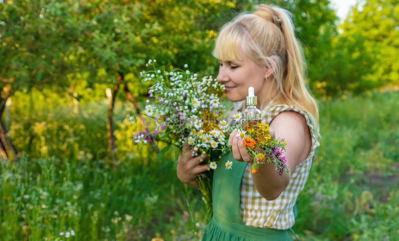 A woman makes herbal tincture. Selective focus. Nature.