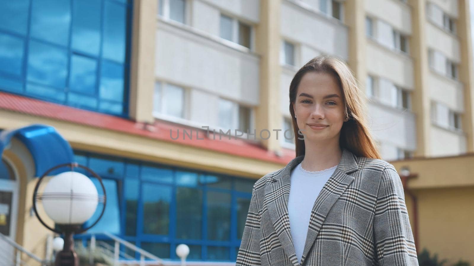 A young girl student in a puffer is walking through town