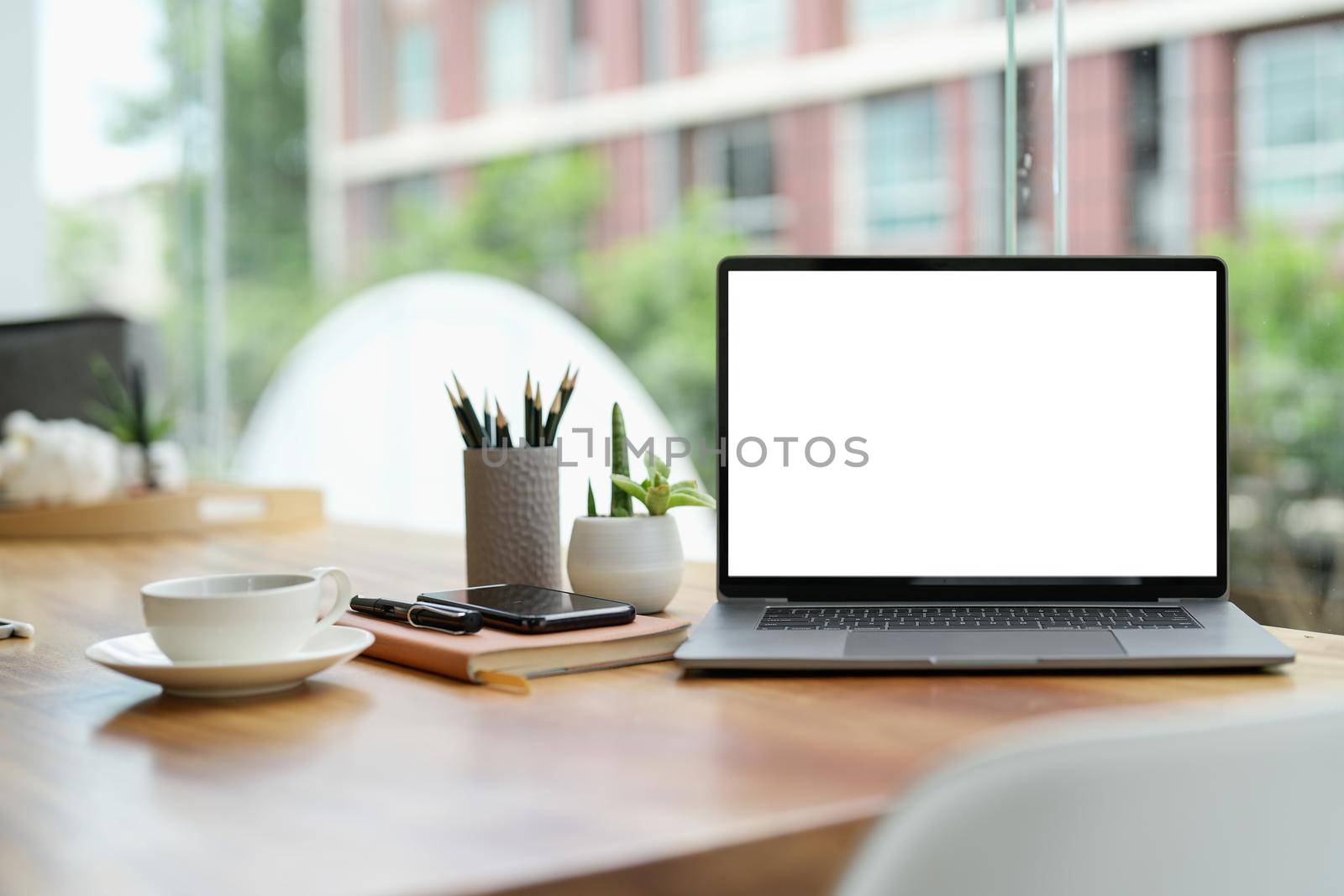 Laptop blank screen on wood table with coffee cafe background, mockup, template for your text, Clipping paths included.