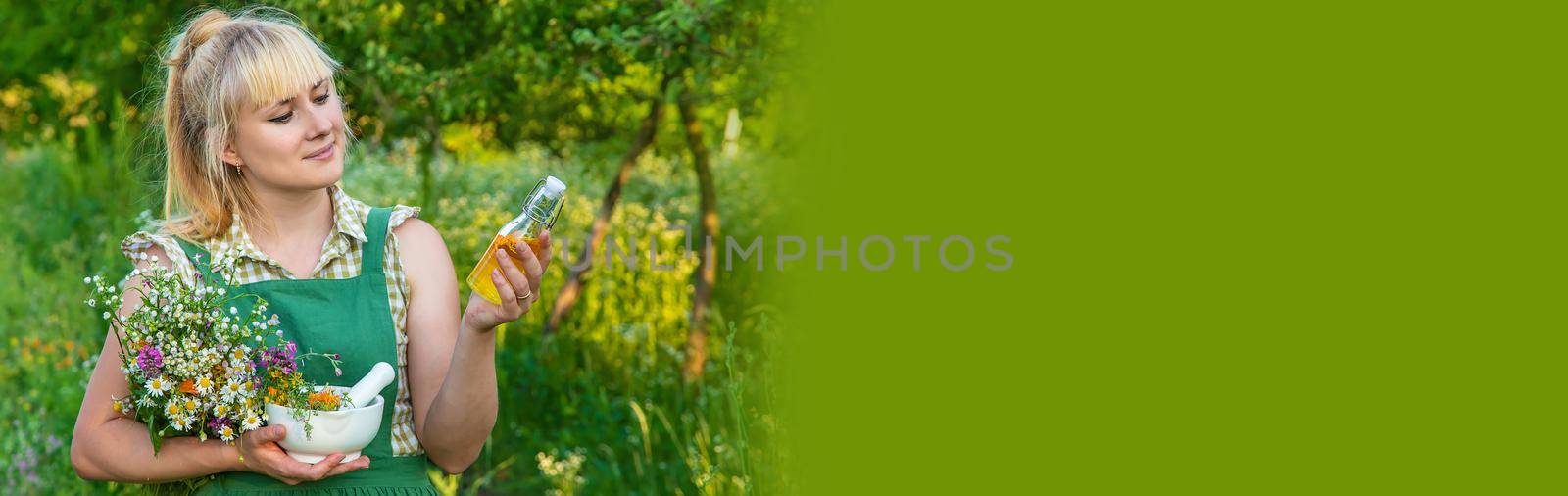 A woman makes herbal tincture. Selective focus. Nature.