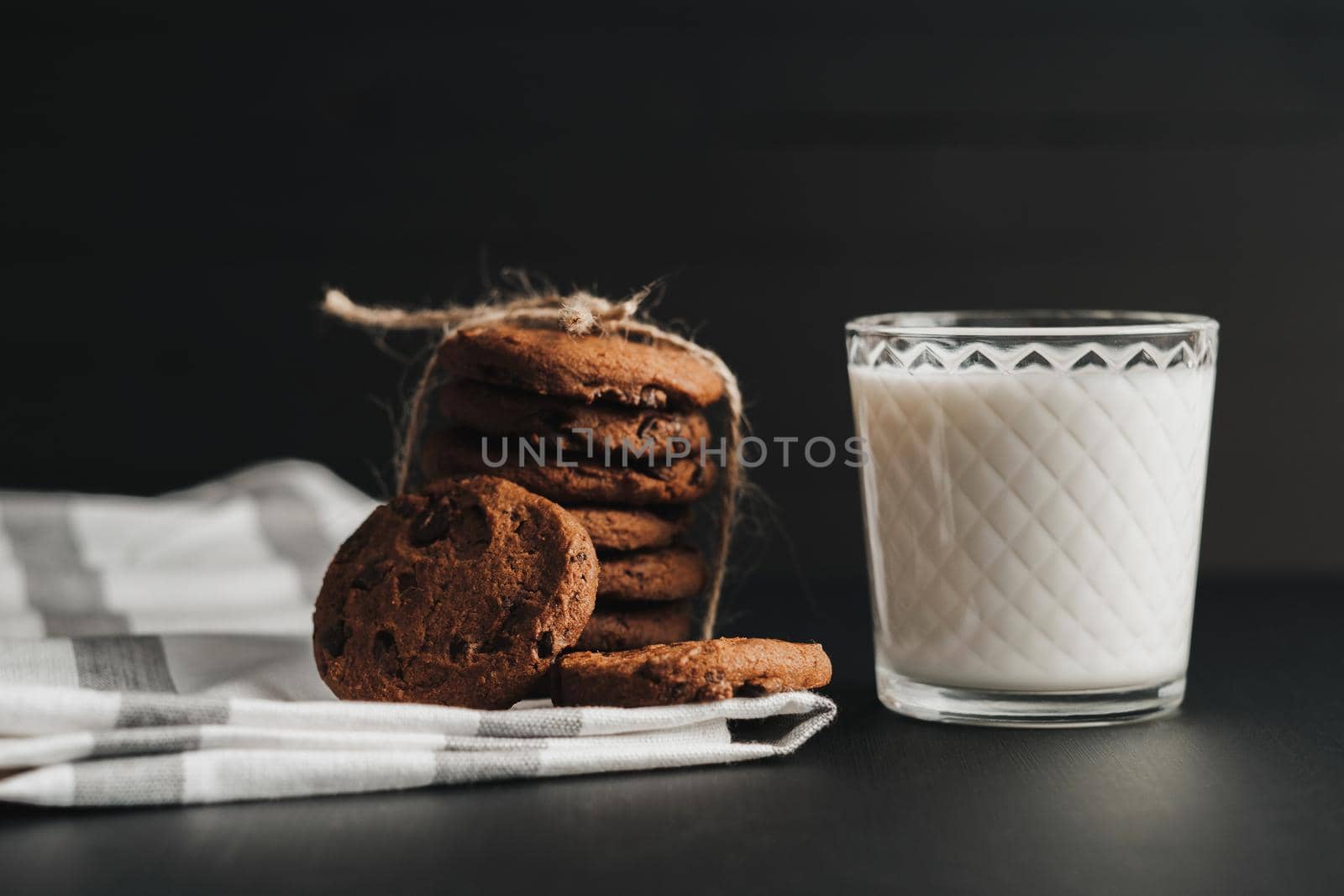 Glass is Filled with Milk and Homemade Cookies on Black Table