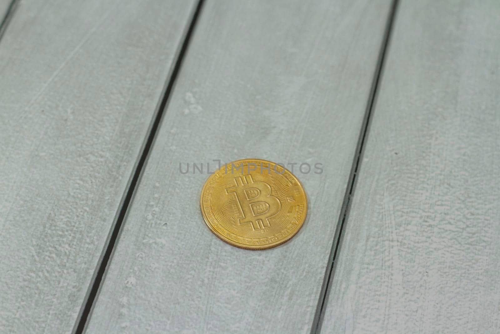 bitcoin gold coin on gray wooden background. Online payment technology, digital wallet, computer financial, digital blockchain, bitcoin stock, cryptocurrency trading and mining investment concept.