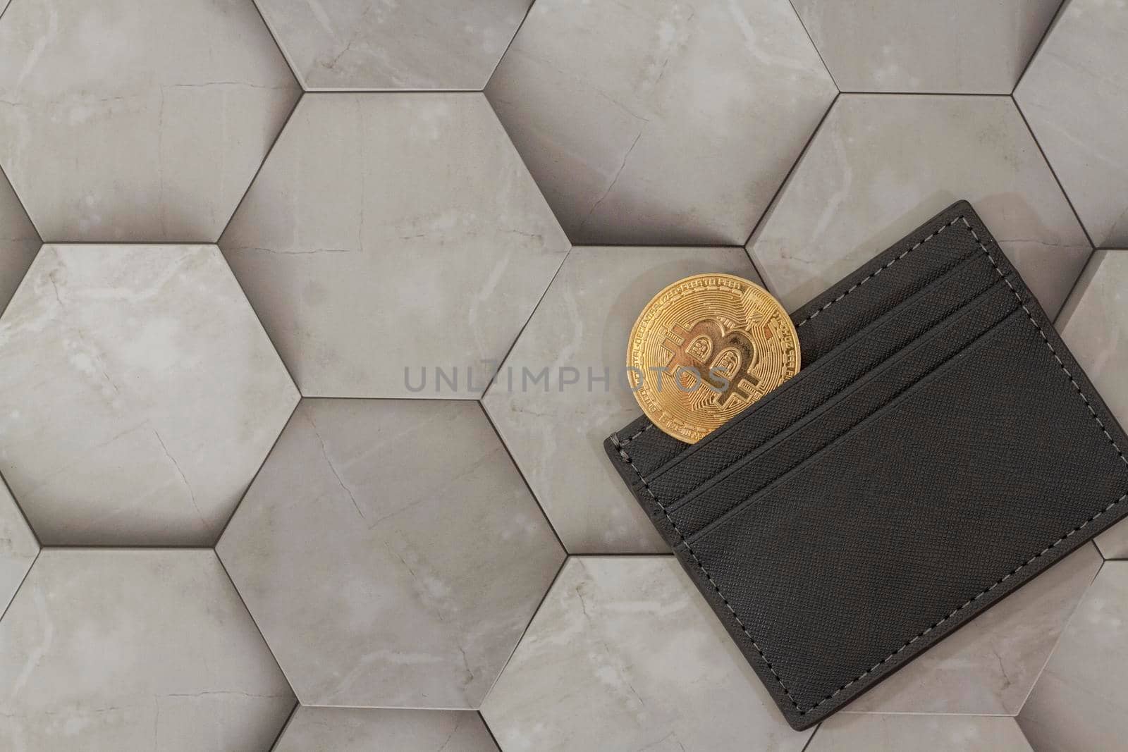 bitcoin gold coin place in wallet on hexagon gray background. Online payment technology, digital wallet, computer financial, digital blockchain, bitcoin stock, cryptocurrency trading and mining investment concept.