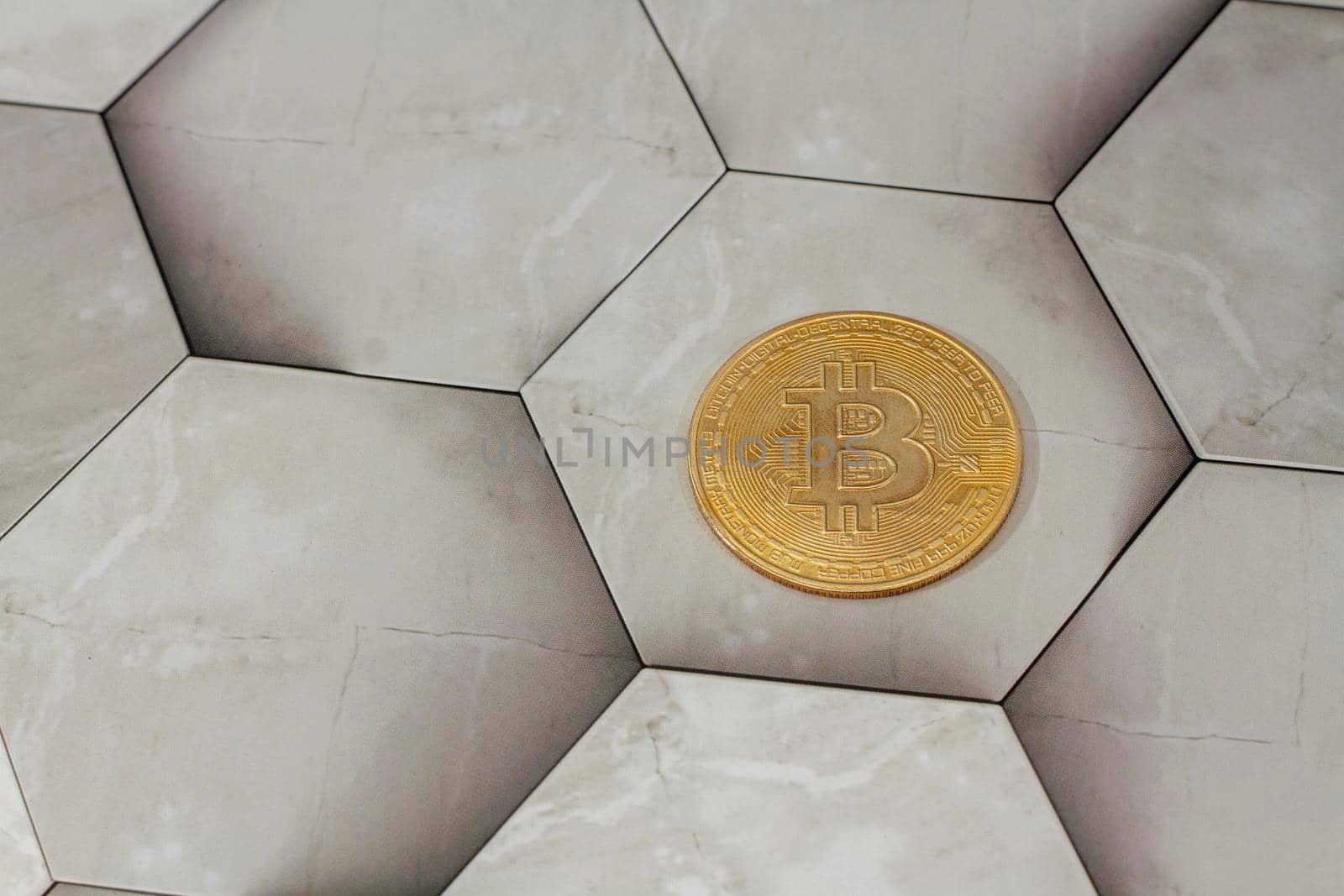 bitcoin gold coin place on hexagon gray background. Online payment technology, digital wallet, cryptocurrency trading and mining investment concept. by Hitachin