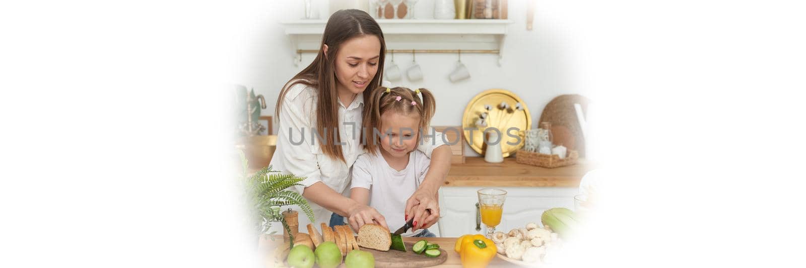 Mom controls her daughter's cutting vegetables. Cooking training. Web banner.