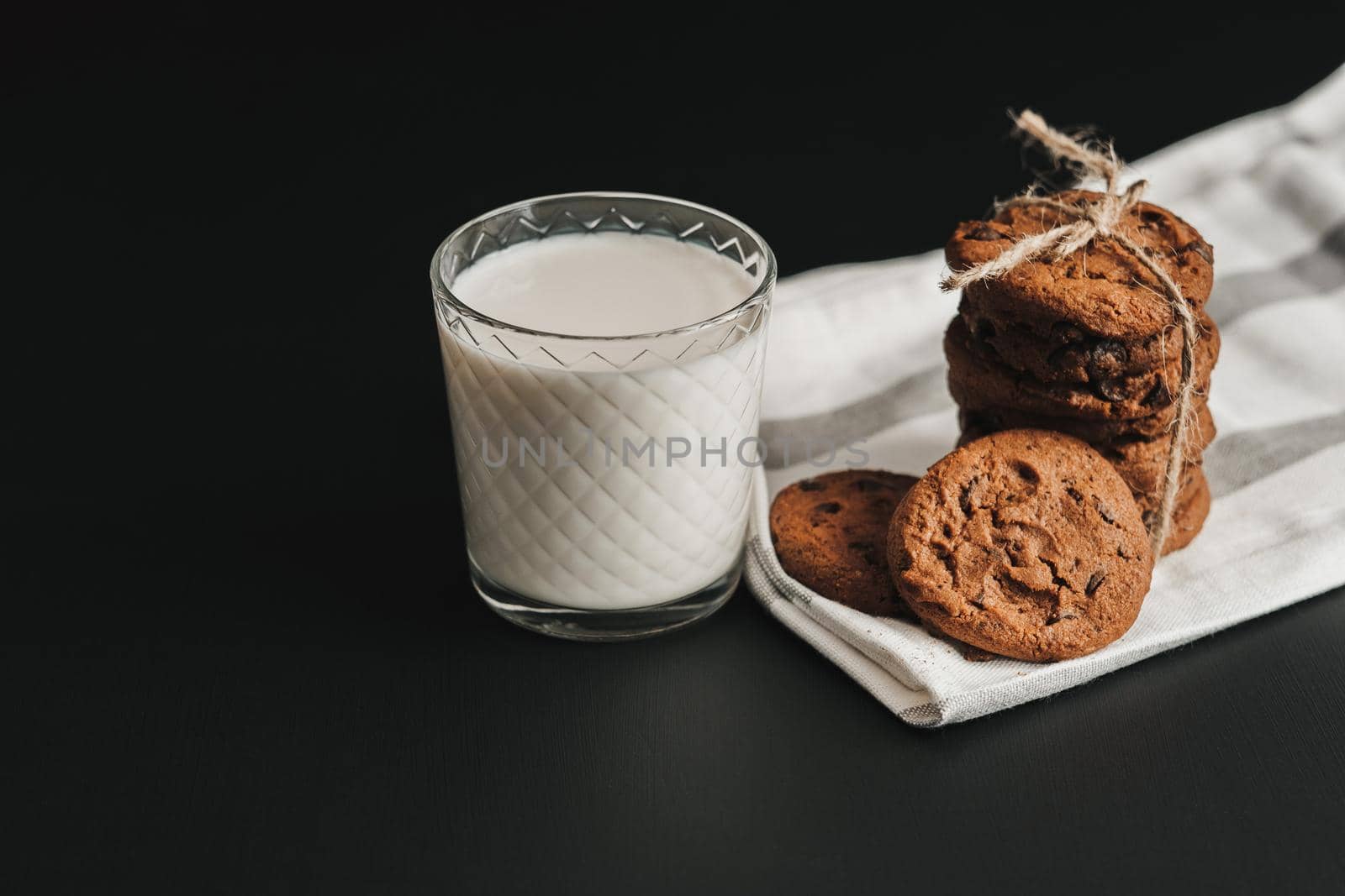 Glass is Filled with Milk and Homemade Cookies on Black Table