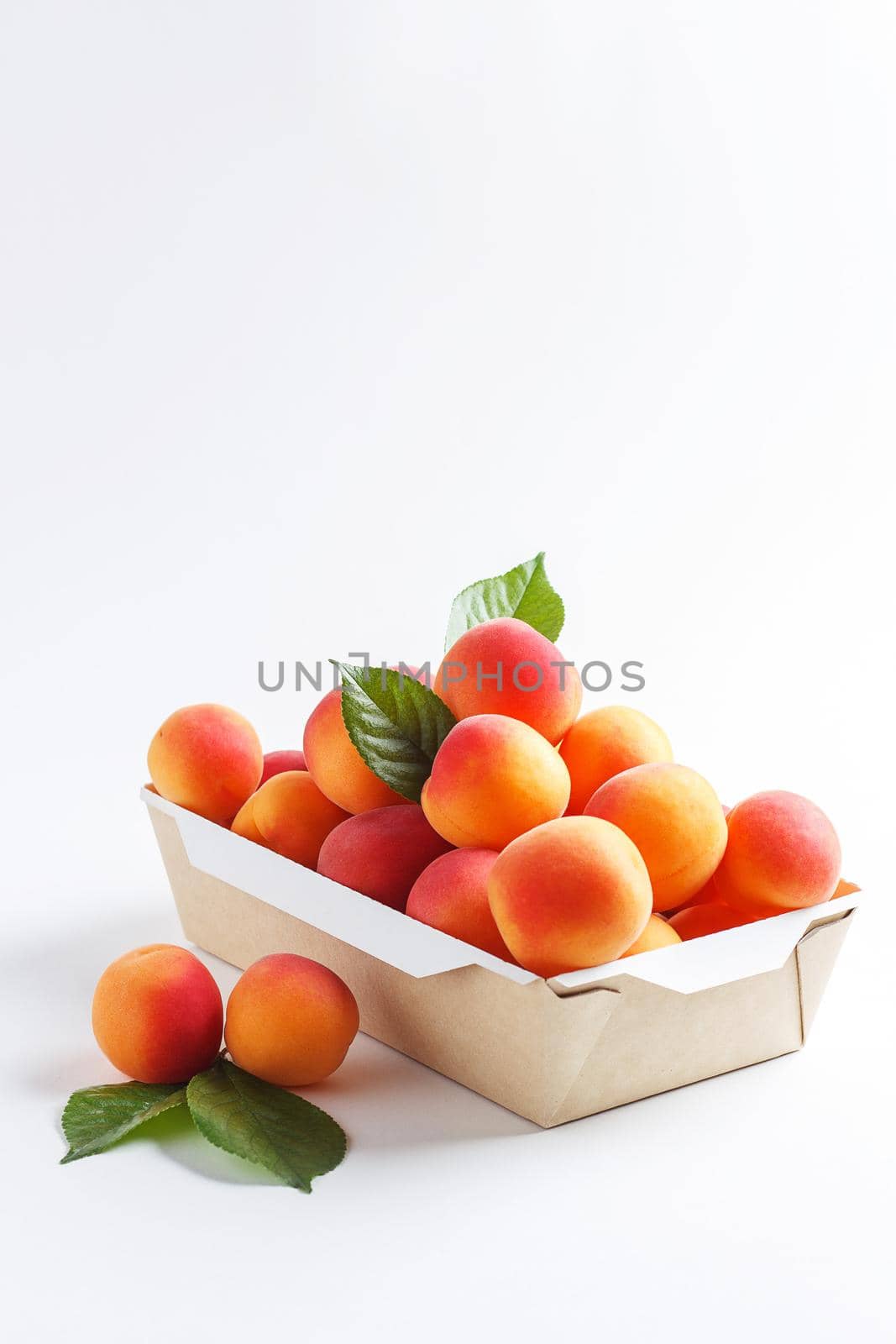 Apricots in paper packaging on a white background. the concept of eco-friendly packaging without plastic. Copy space