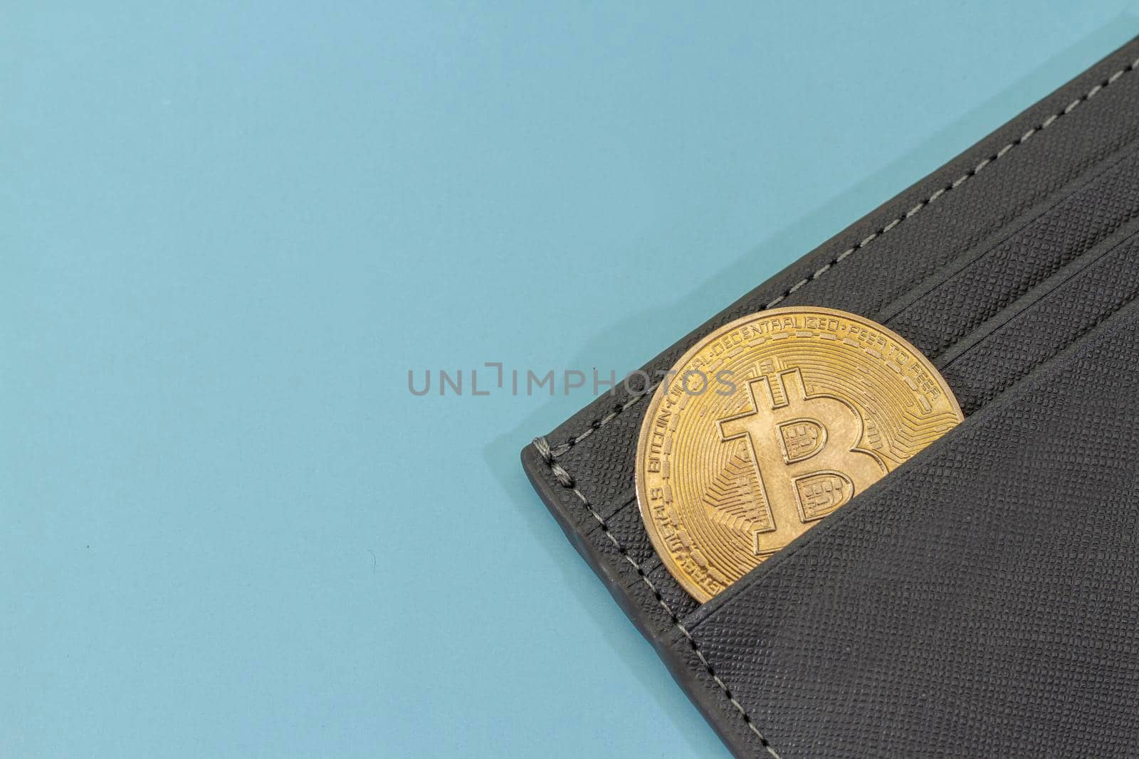 bitcoin gold coin place in wallet on blue background. Online payment technology, digital wallet, computer financial, digital blockchain, bitcoin stock, cryptocurrency trading and mining investment concept.
