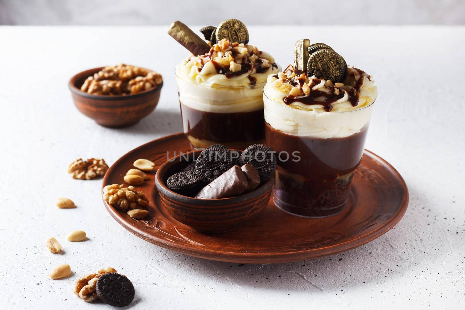 Delicious chocolate trifle or pudding with whipped cream in a glass on a gray background. by lara29