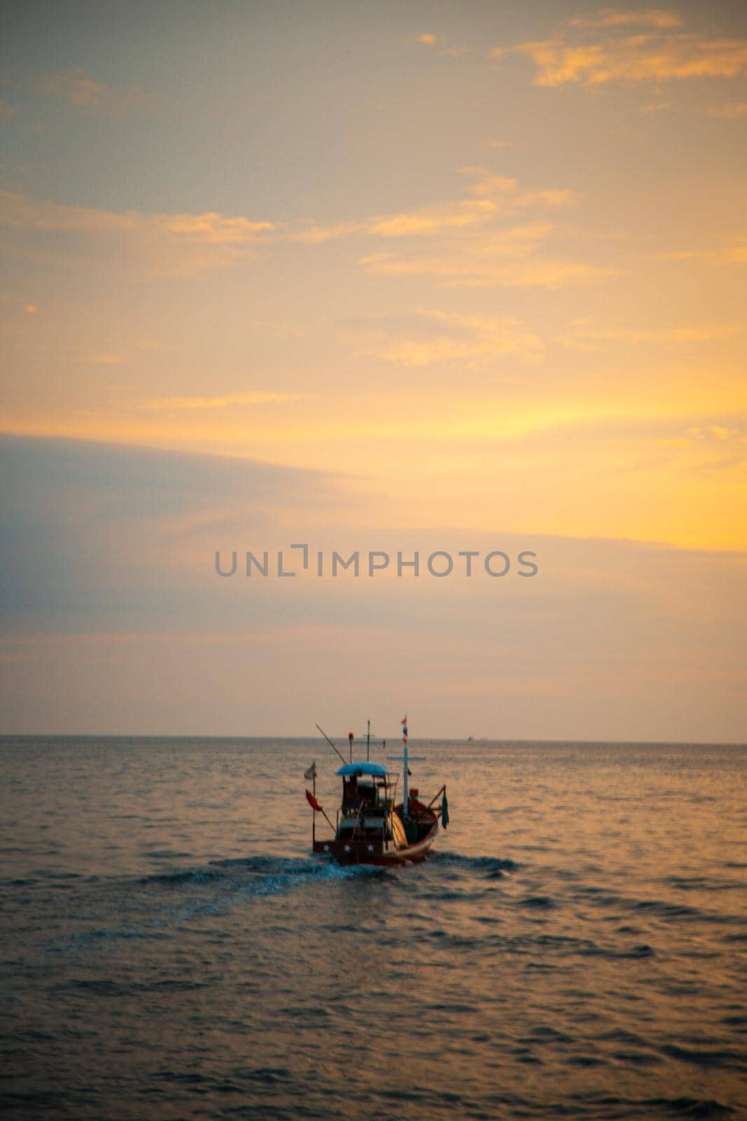 Sailing boat during sunset at Promthep Cape in Phuket peninsula, Thailand. High quality photo