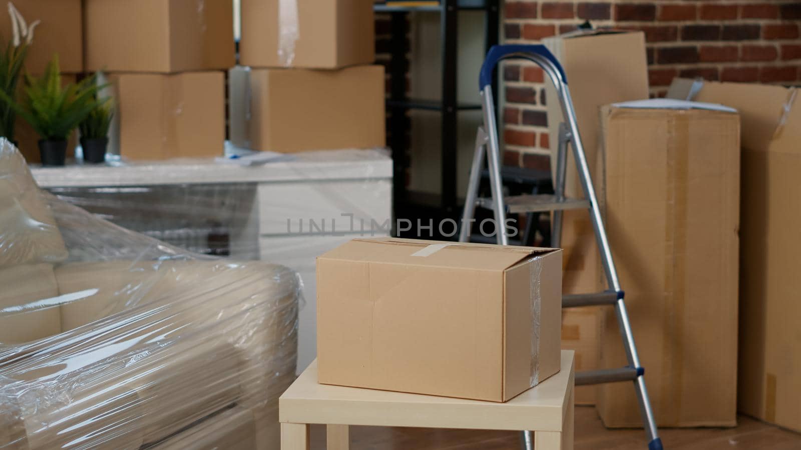 African american couple using cardboard boxes to move in new apartment flat together, starting new beginnings. Household relocation in rented property on mortgage loan. Handheld shot.