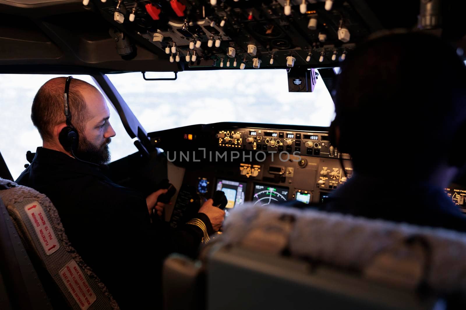 Plane pilot pushing buttons to start power on dashboard control, using panel command in cabin to fly airplane. Aircrew flying aircraft jet with radar compass and aerial navigation.