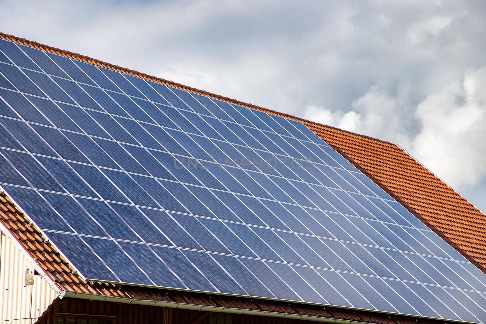 solar panels on the roof of a house. horizontal orientation, blue sky. Energy concept