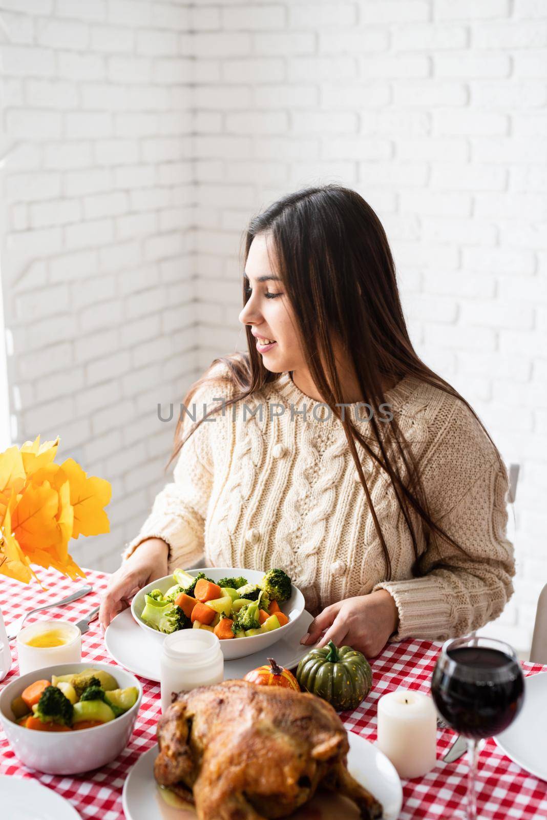 Happy Thanksgiving Day. Autumn feast. Woman celebrating holiday eating traditional dinner at kitchen