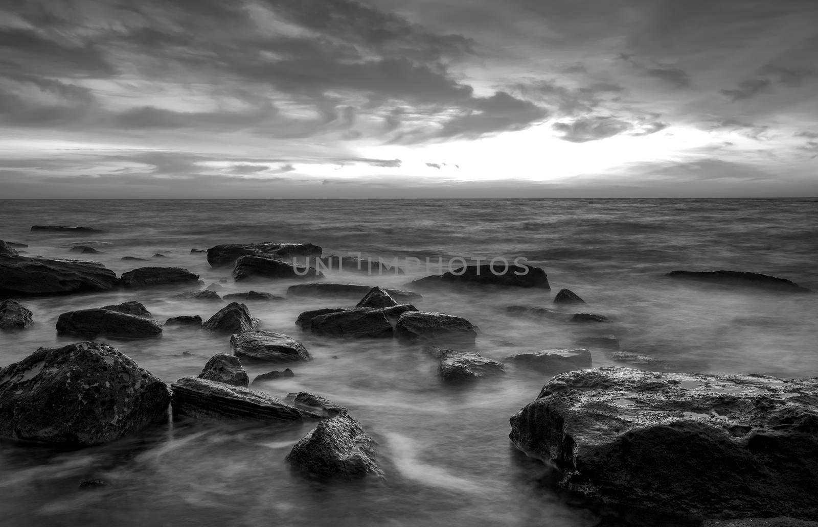 Stunning black and white long exposure seascape at cloudy day.