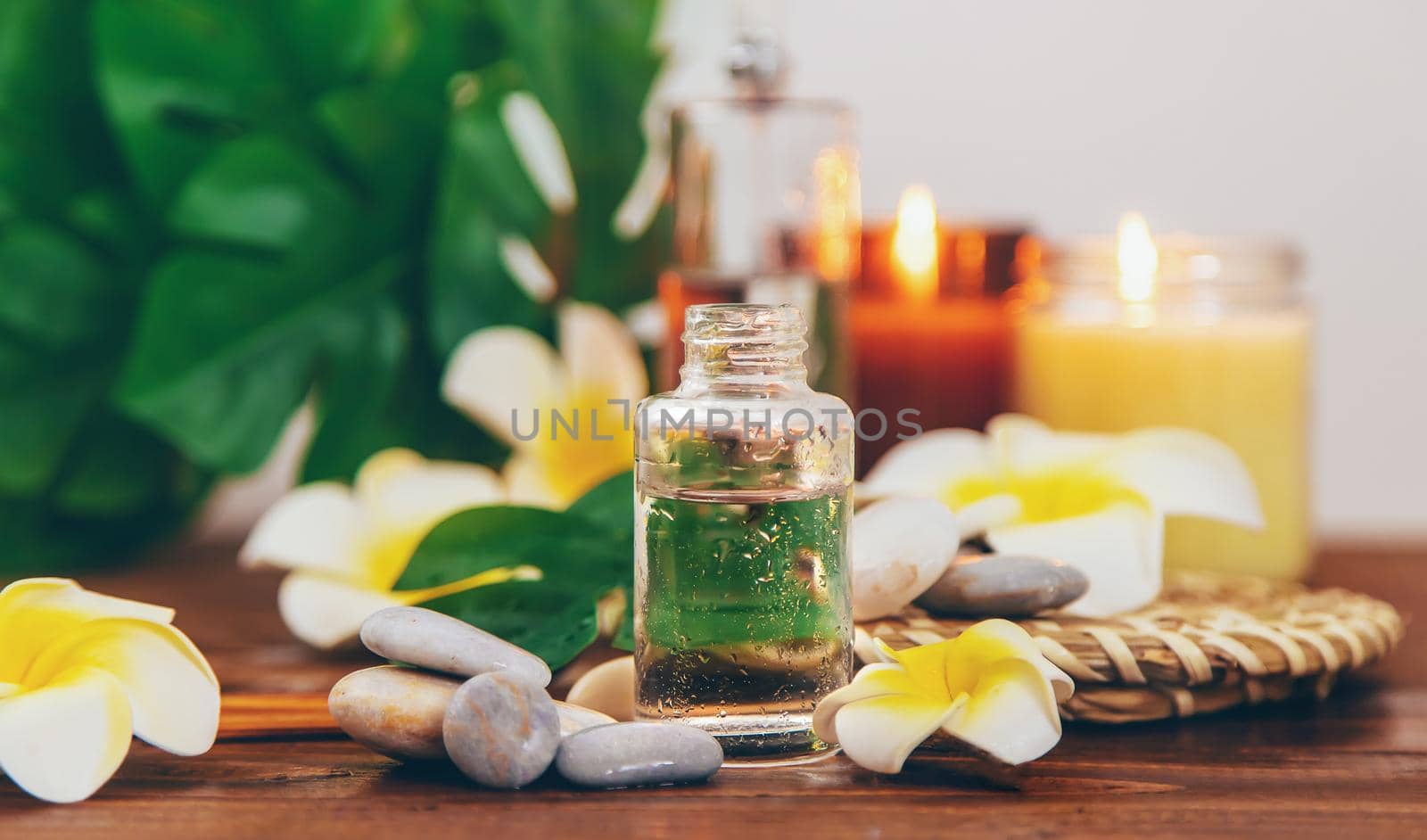 Spa oils with plumeria flowers. Selective focus. Natural.
