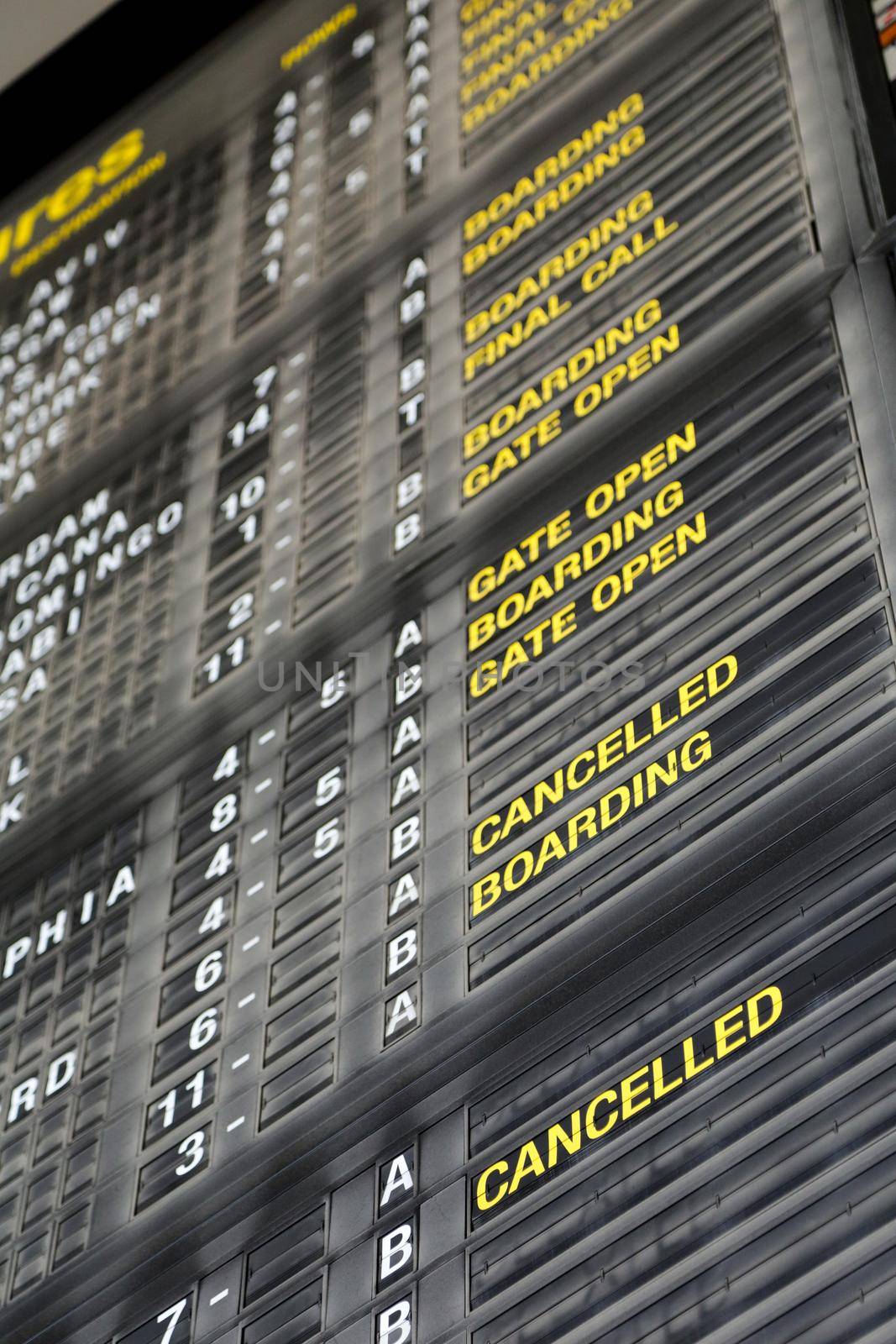 Airport departure board in terminal with flight information