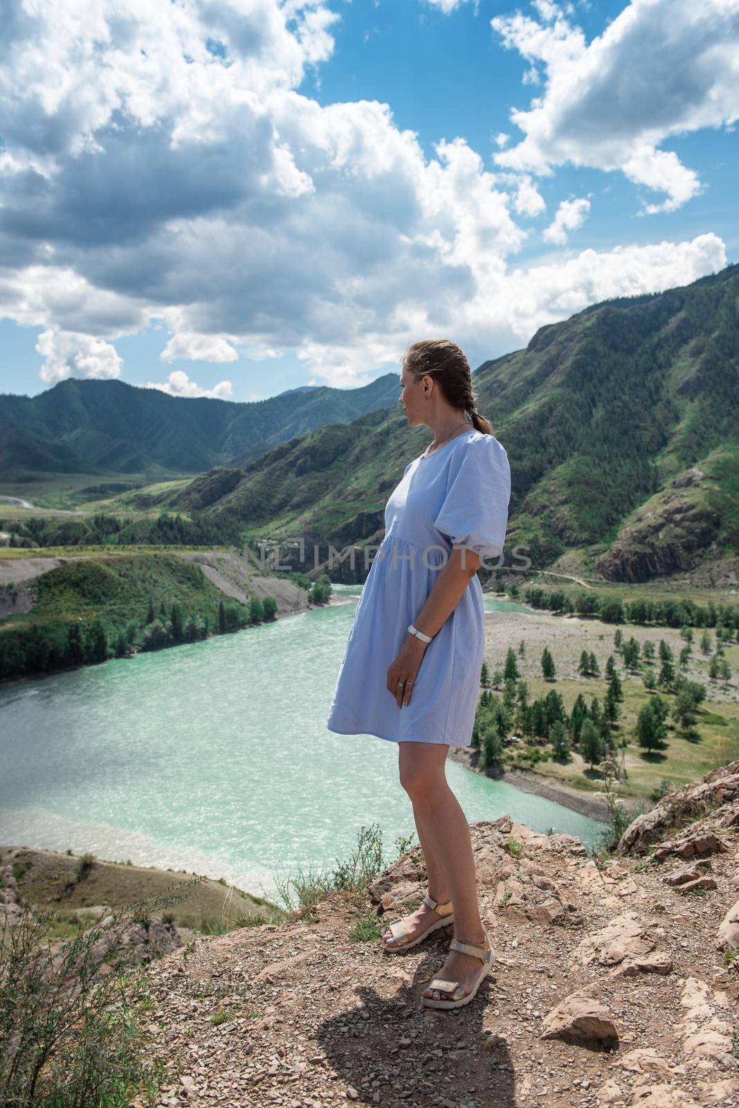 Woman in blue dress on the confluence of two rivers Katun and Chuya by rusak