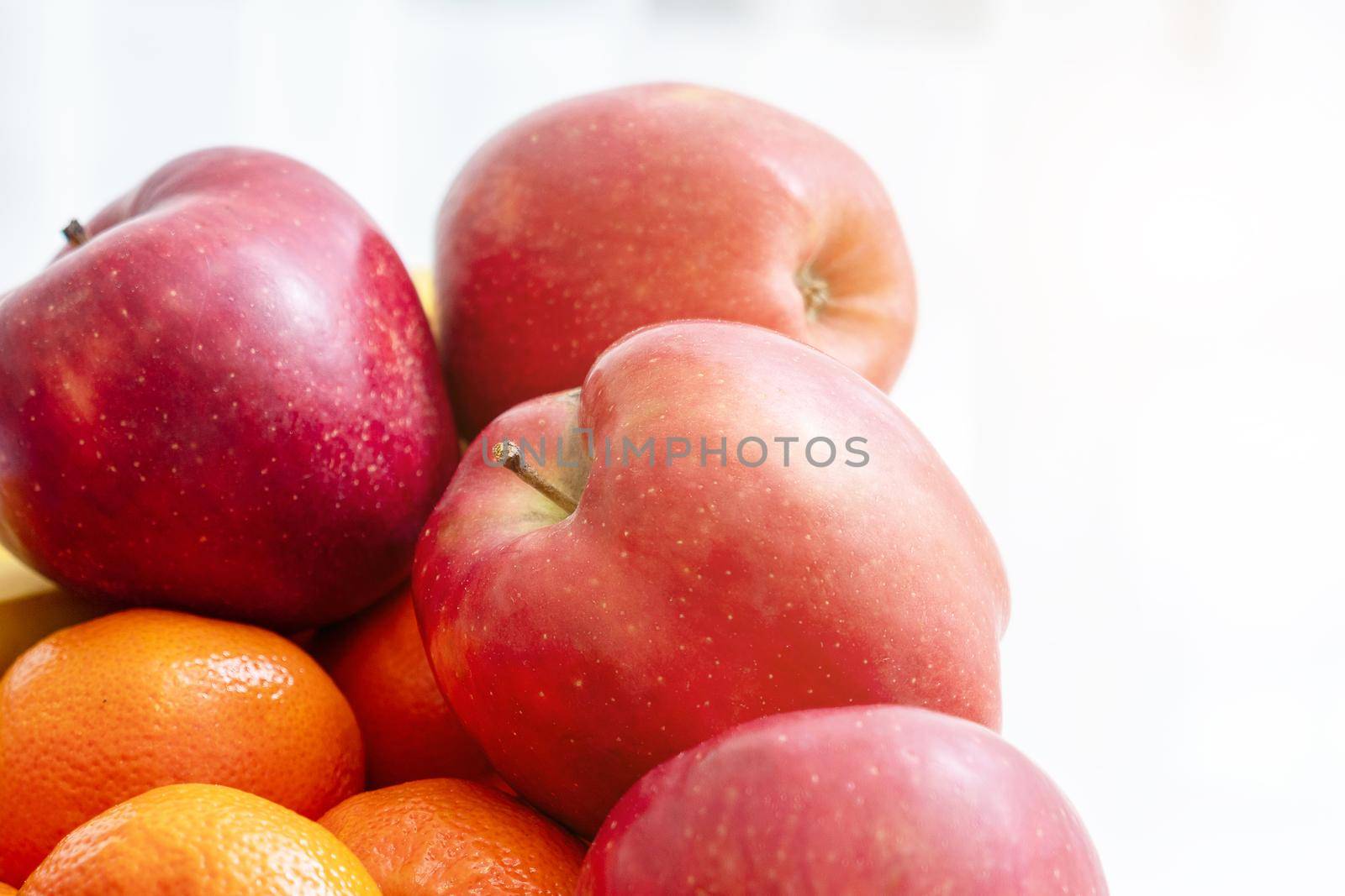 A bowl of fruit on white background. Apples and oranges by Mariakray