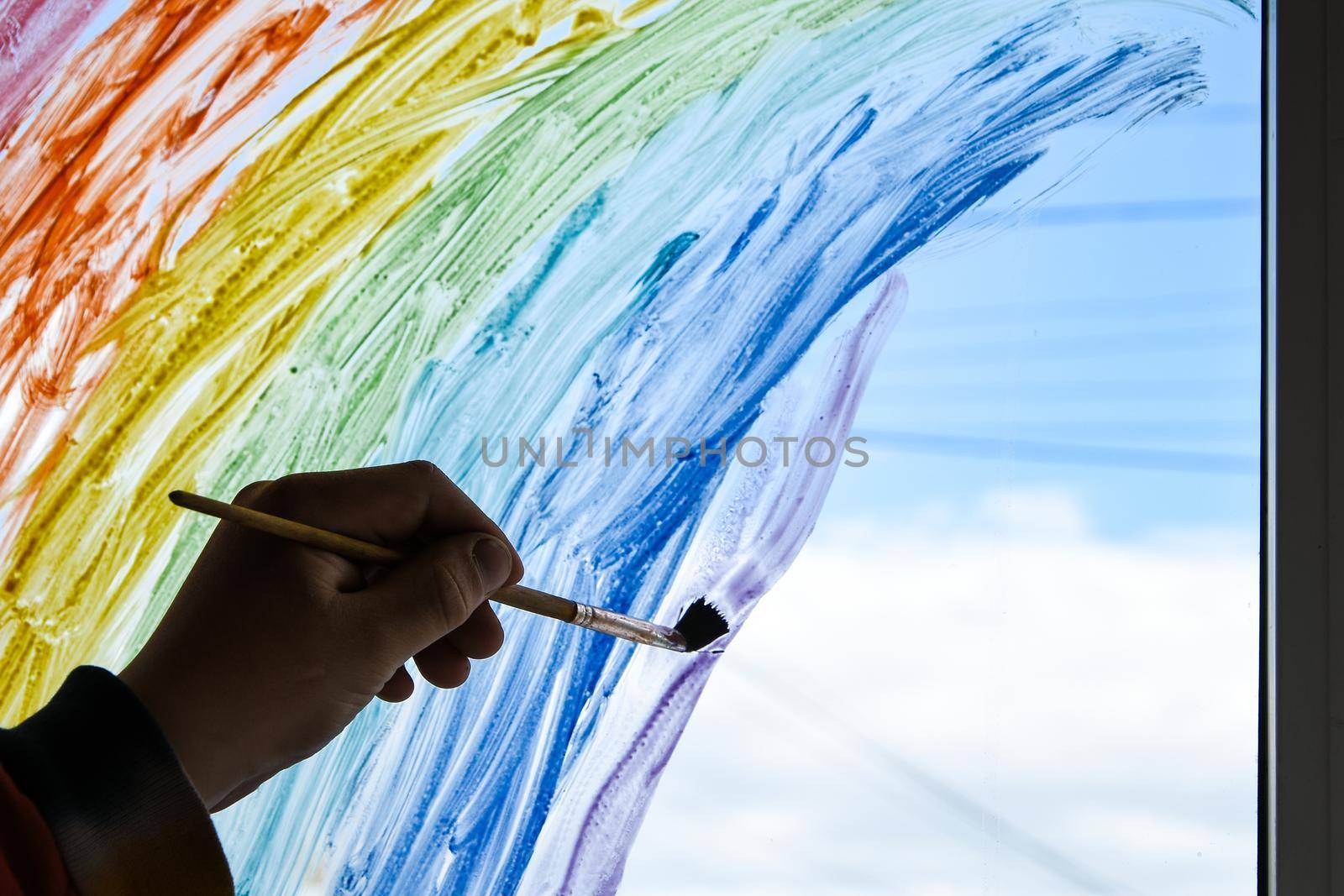 hand painting rainbow on a window, stay home during quarantine, Image of kids leisure at home, Chase the rainbow flashmob