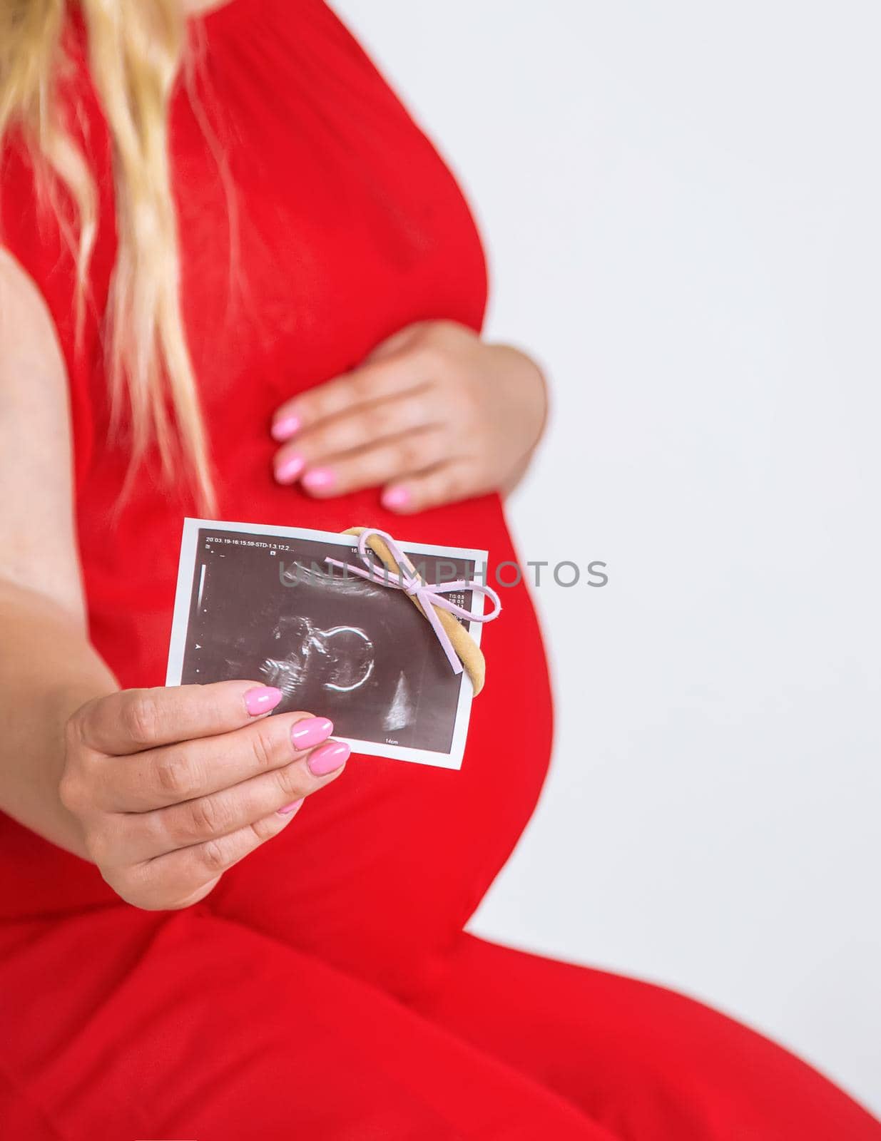 Pregnant woman with girl ultrasound picture. Selective focus. by yanadjana