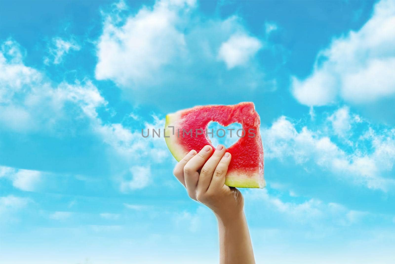 A child on a picnic eats a watermelon. Selective focus. Food.