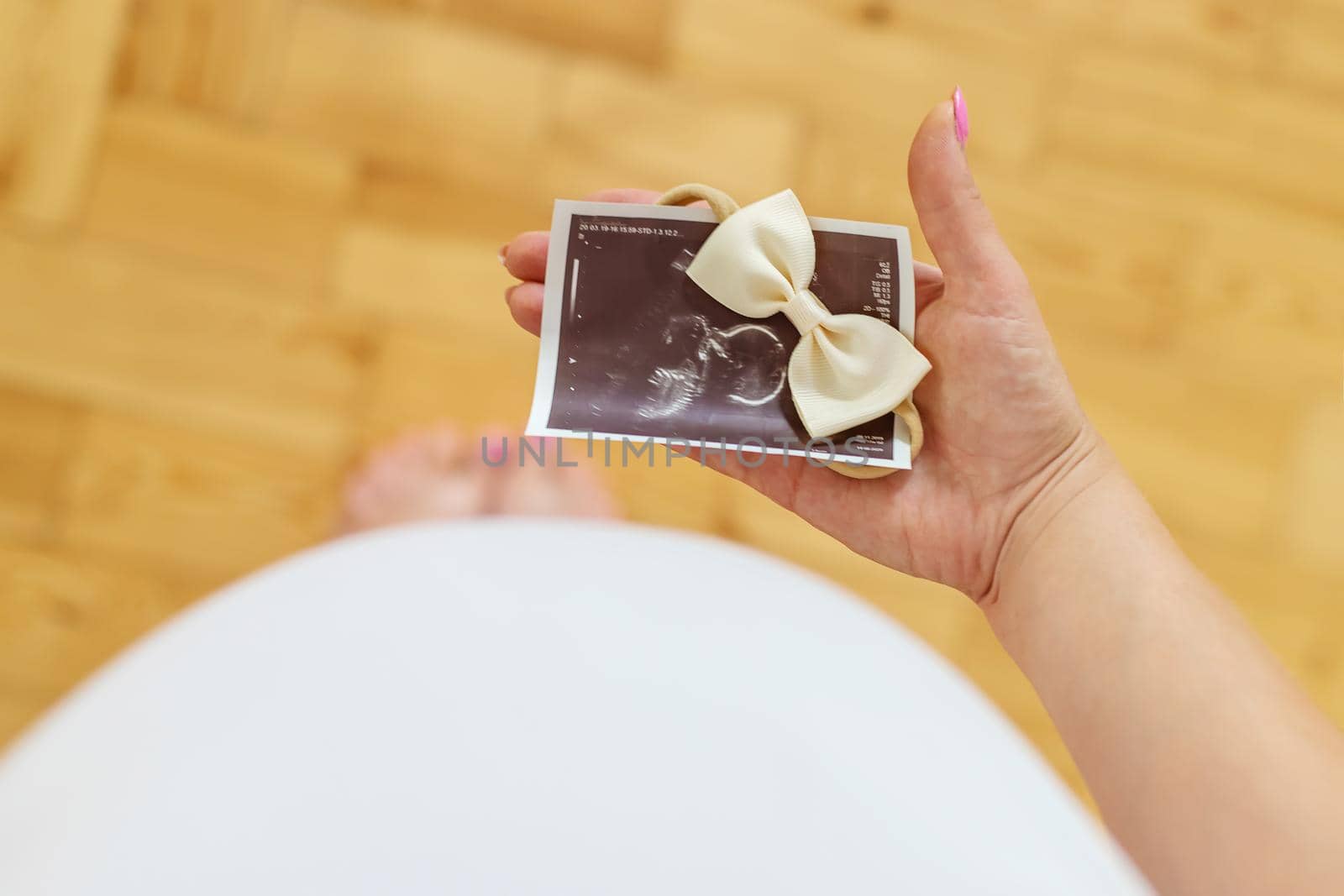 Pregnant woman with girl ultrasound picture. Selective focus. by yanadjana