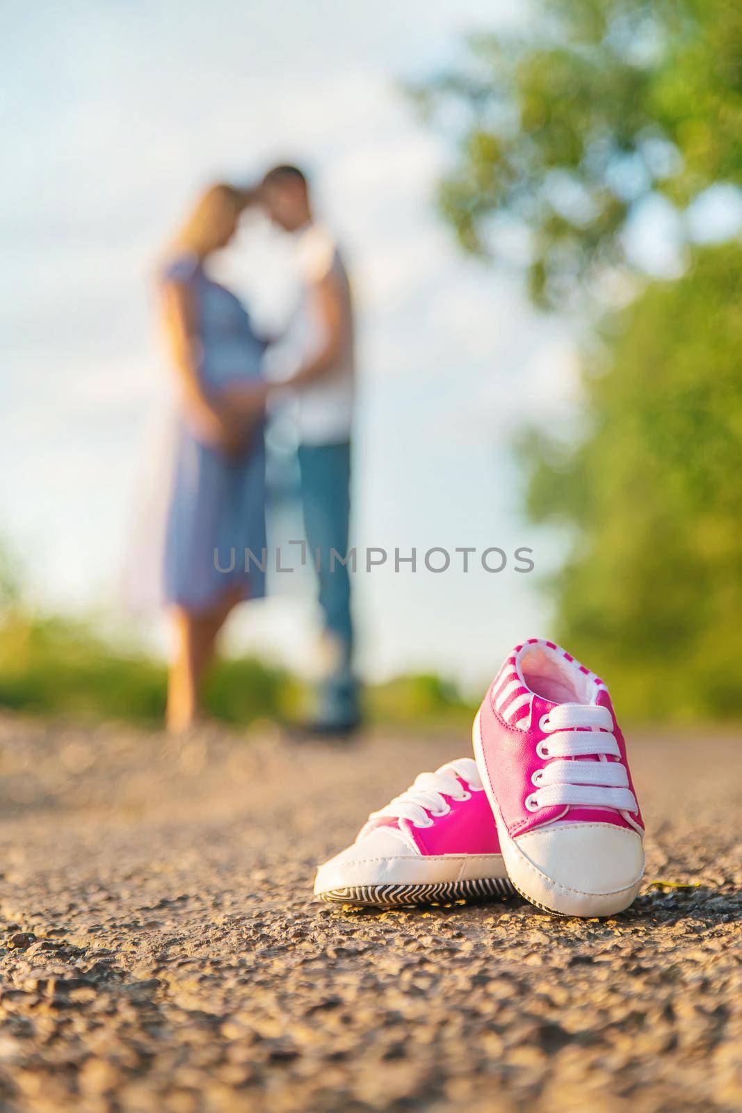 Pregnant woman and man baby shoes. Selective focus. by yanadjana