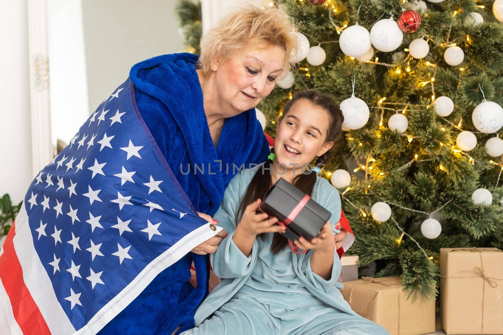 grandmother and granddaughter christmas with usa flag.