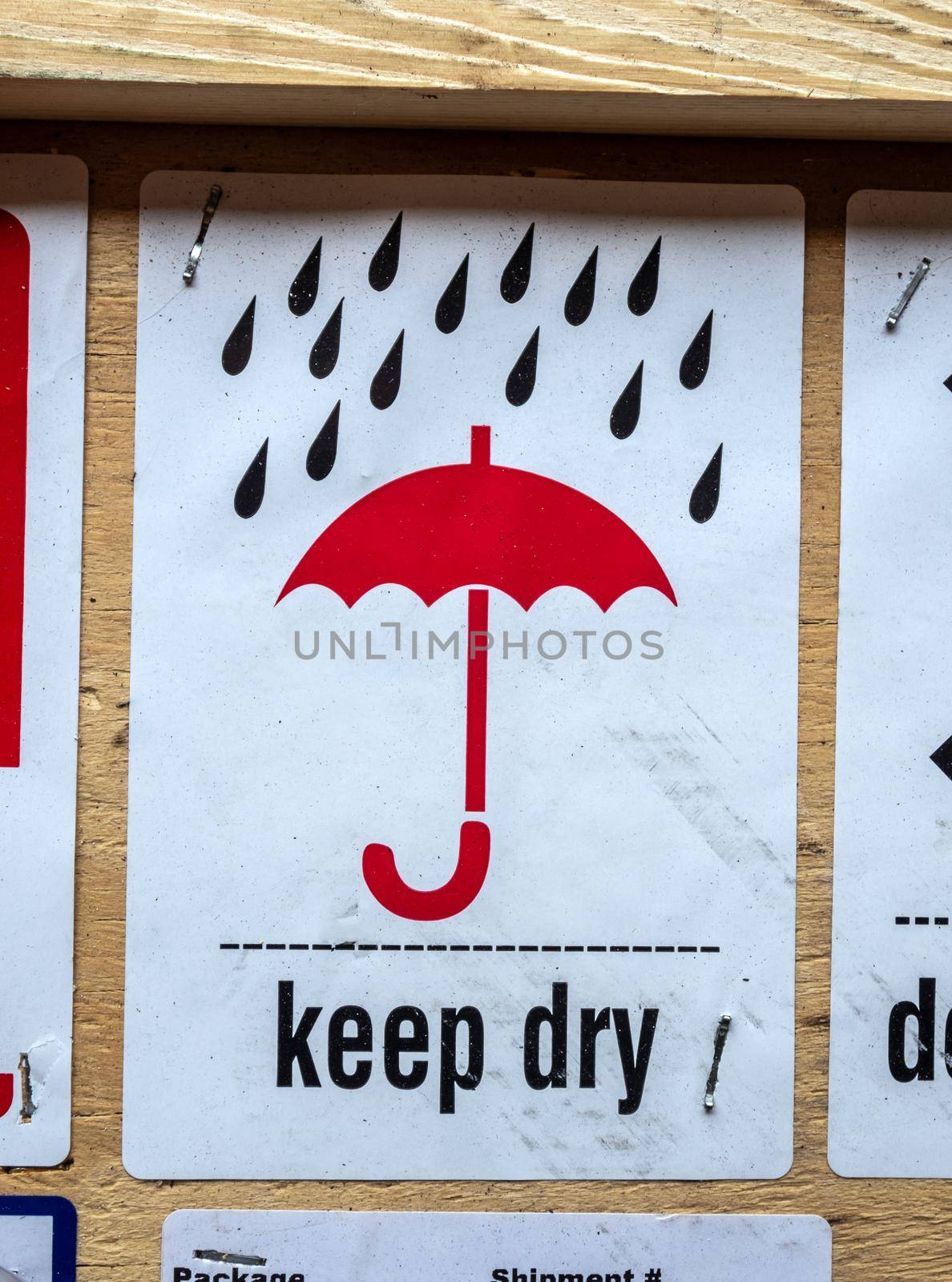 Keep-dry symbol information label beside transportation wooden box by Satakorn