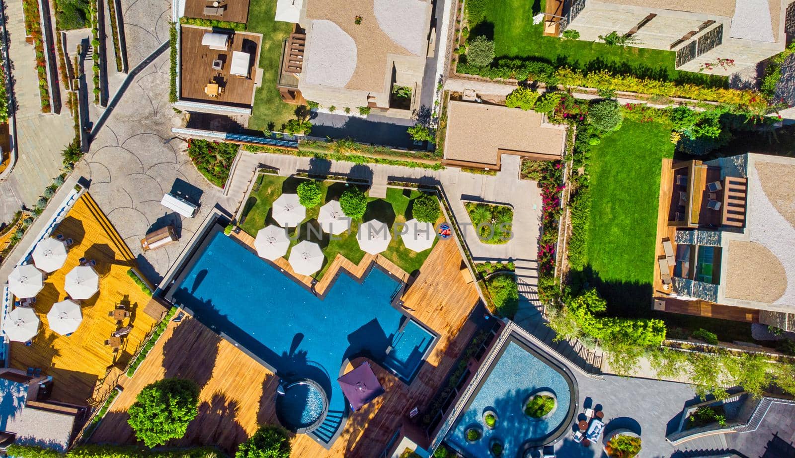 Swimming Pool viewed from above. Top down view of modern luxury villa with swimming pool