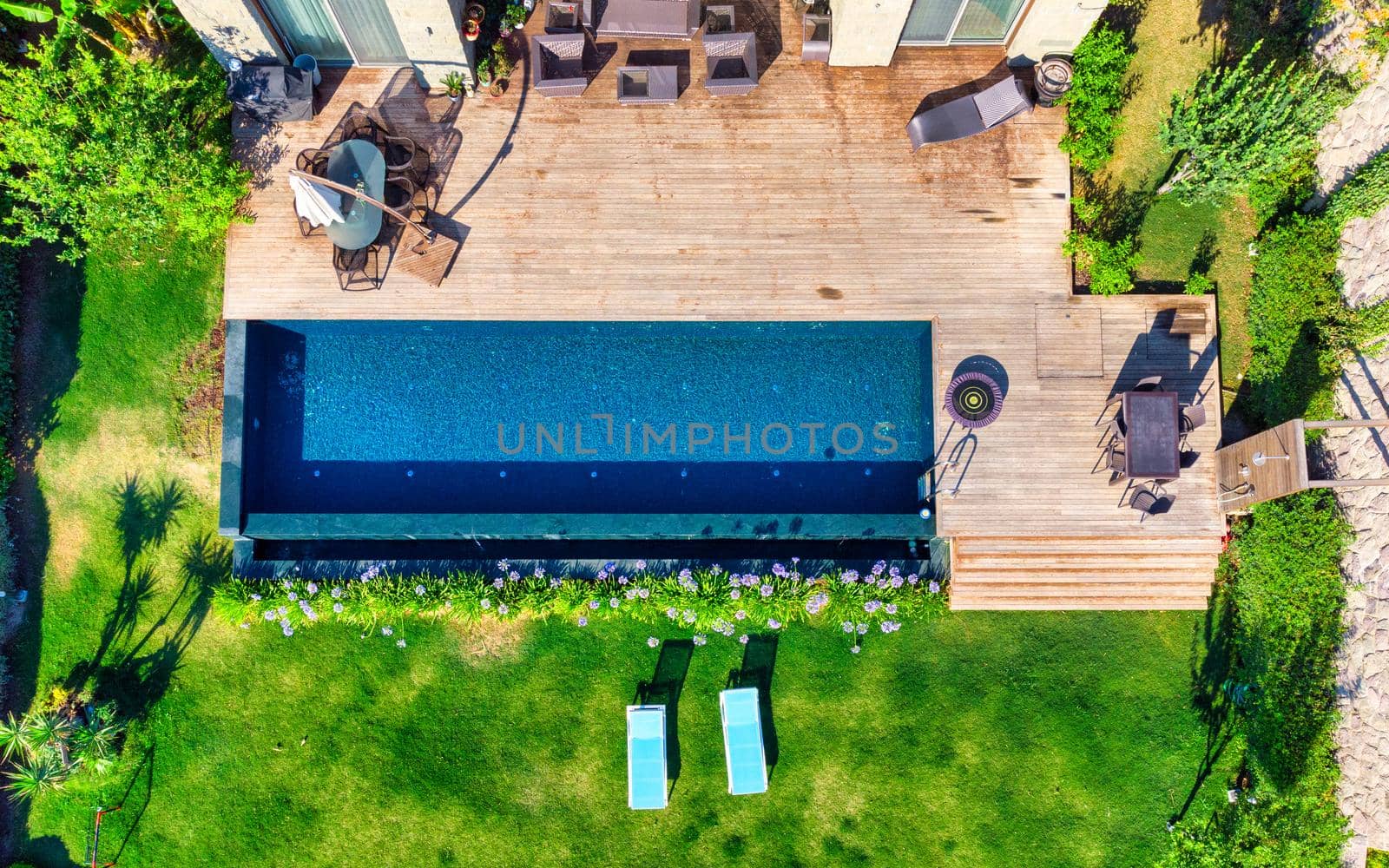 Swimming Pool viewed from above. Top down view of modern luxury villa with swimming pool. Aerial luxury resort landscape, resort hotel swimming pool, vacation background