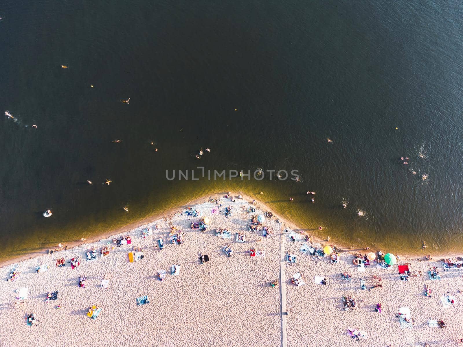 Aerial view on coastline. Summer seascape in sunny day. Top view of people on the beach from drone. Summer seascape from air. Travel image by igor010