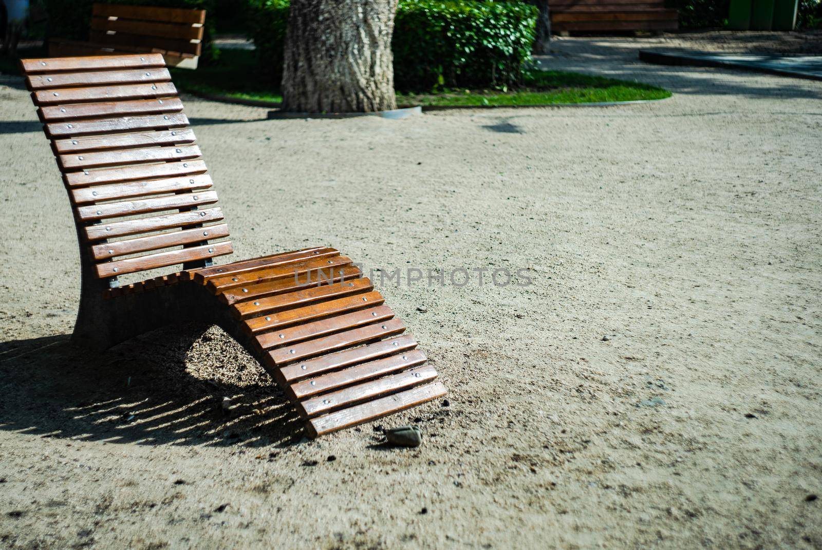 Wooden garden chair outdoor in the summer park