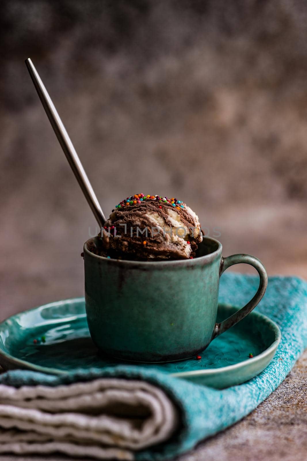 Sweet homemade chocolate ice cream with nuts served in a cup