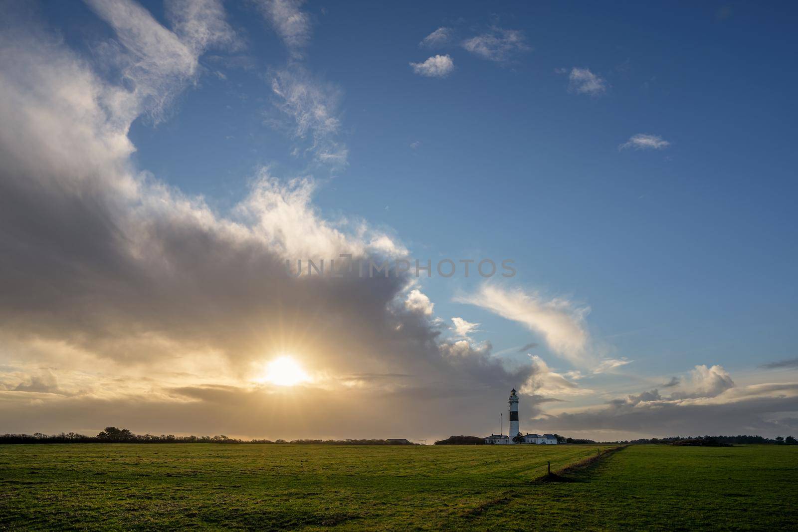 Panoramic image of Kampen lighthouse against dramatic sky, Sylt, North Frisia, Germany 