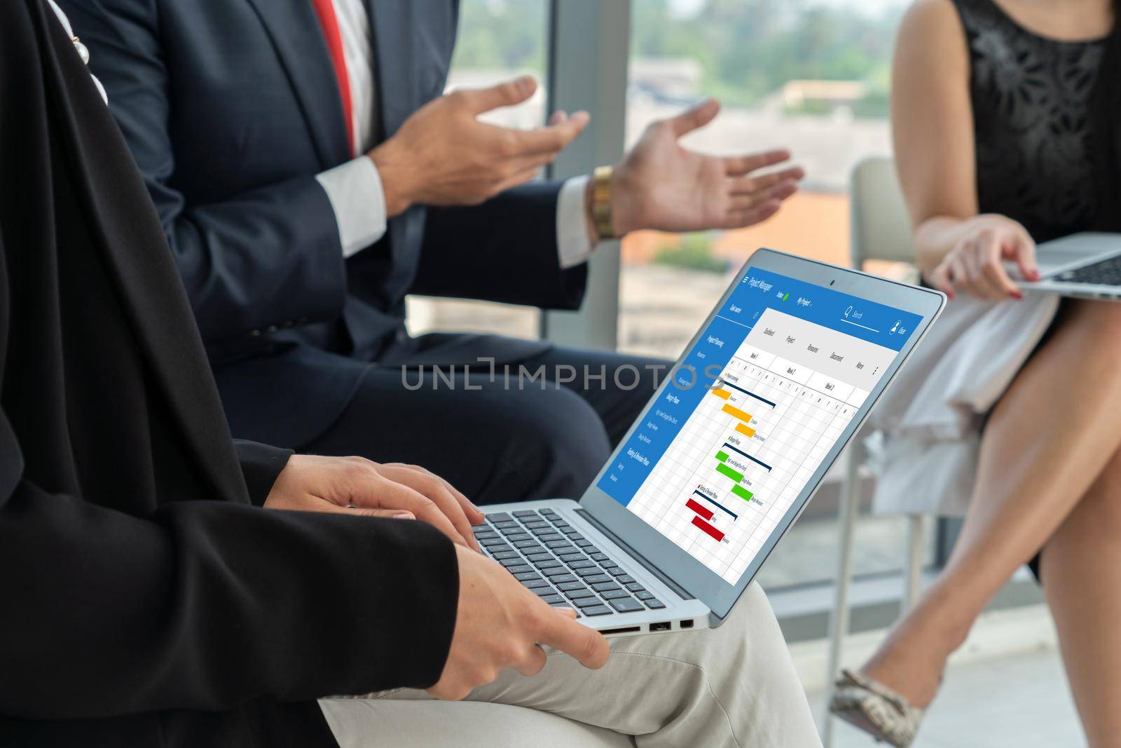 Project planning software for modish business project management on the computer screen showing timeline chart of the team project