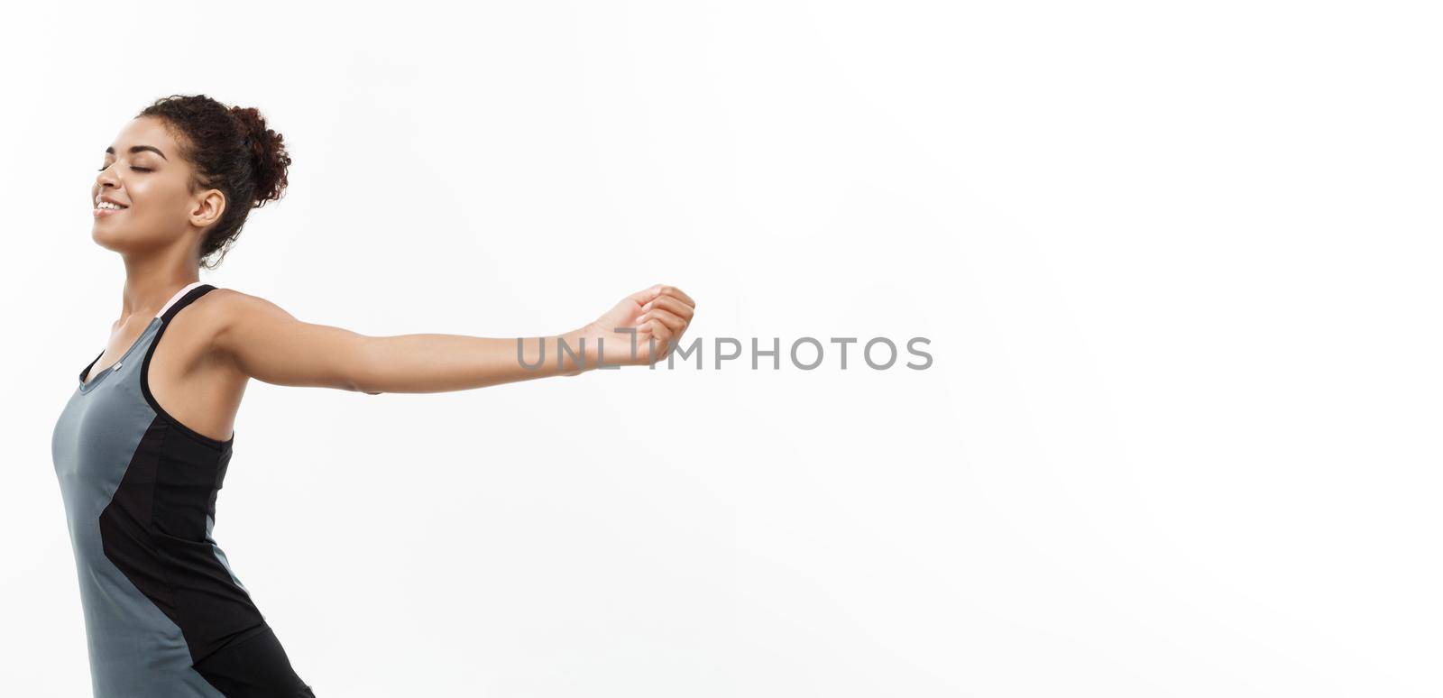Healthy and Fitness concept - Portrait of young beautiful African American with her hands outstretched and closing eyes feeling relax. Isolated on white studio background