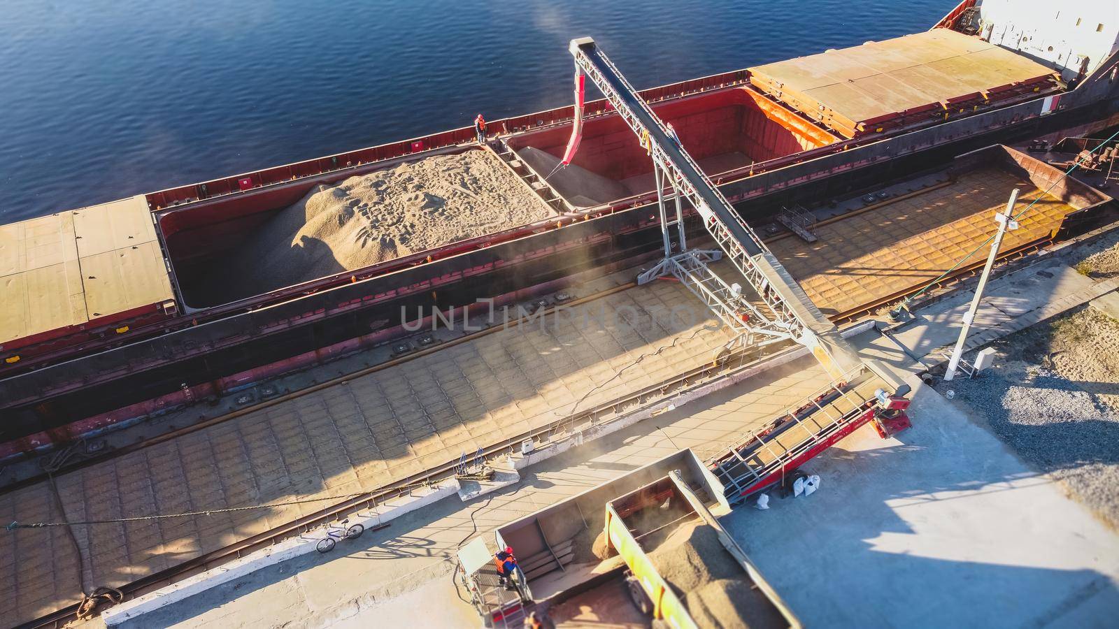 Aerial view of big grain elevators on the sea. Loading of grain on ship. Port Ukraine. Cargo ship. Tank