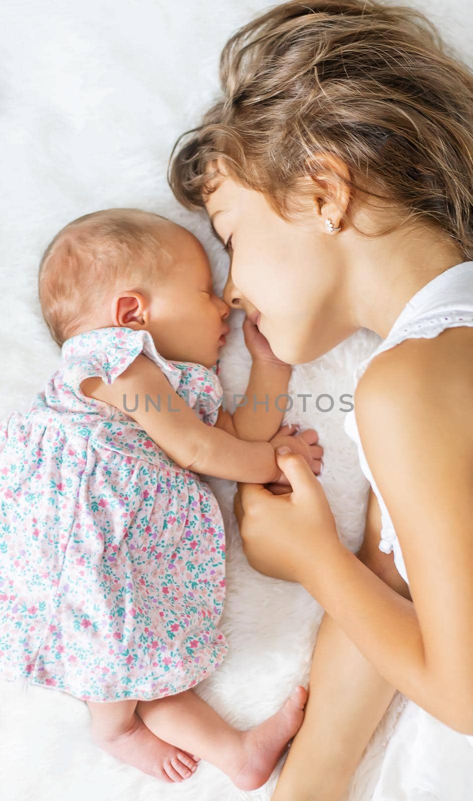 newborn toddler with older sister. selective focus. people.