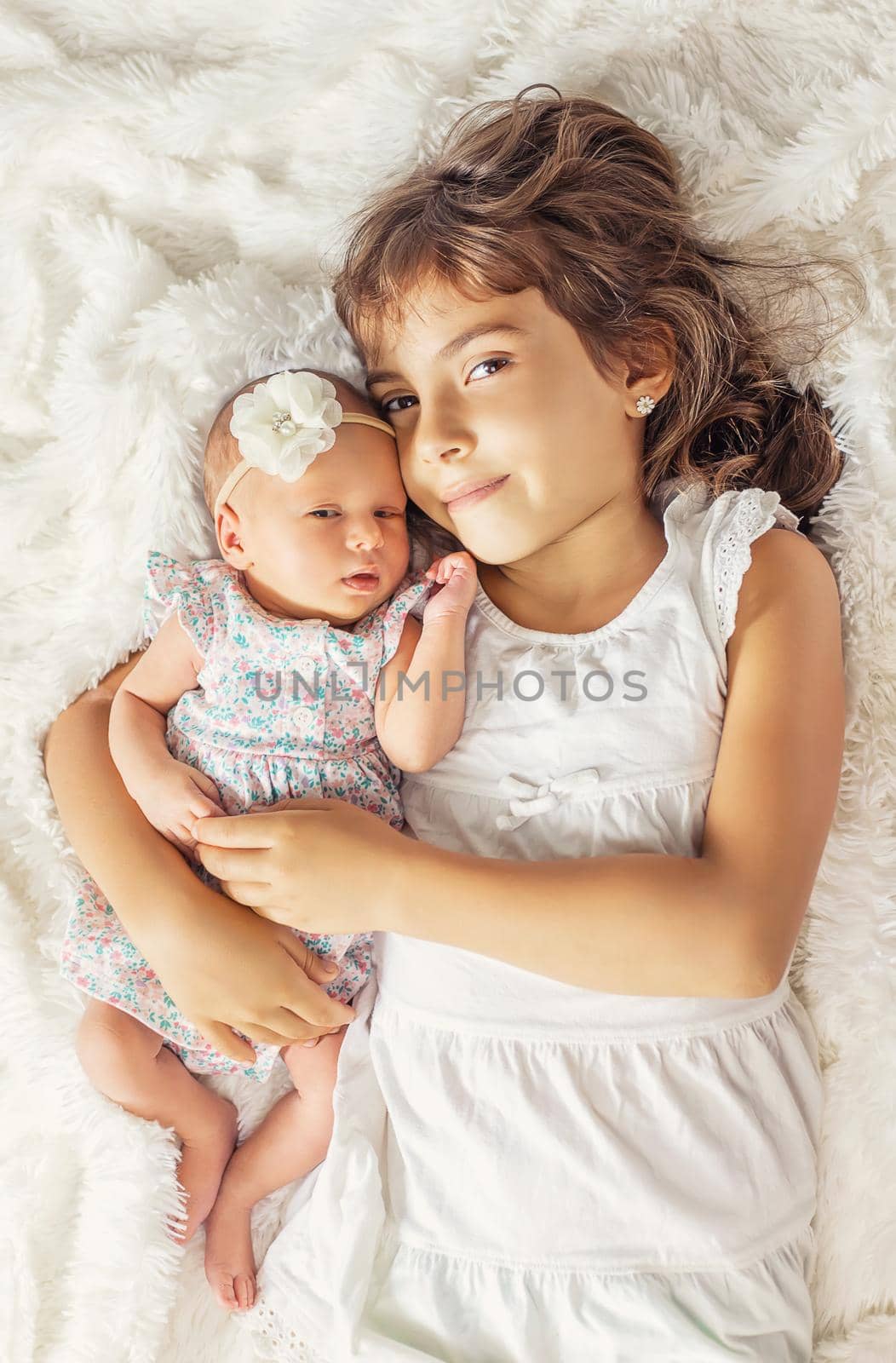 newborn toddler with older sister. selective focus. people.