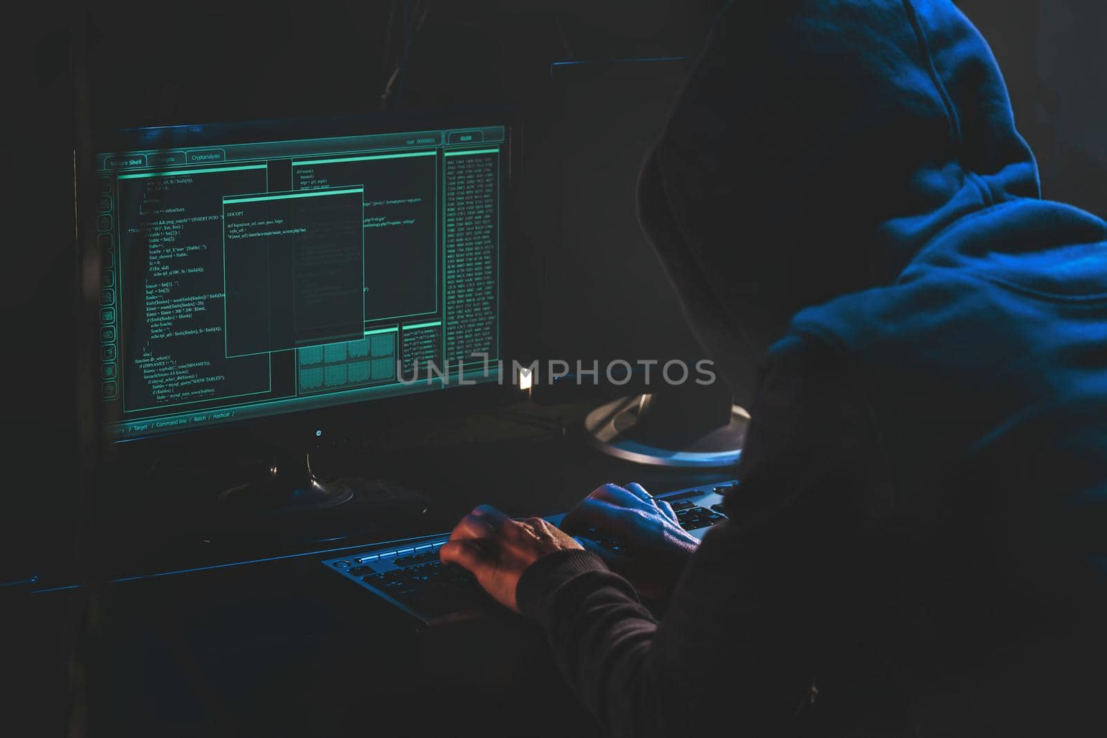 Cyber criminal hacking system at monitors, hacker hands at work. Internet crime concept. Hacker steals password attack victim computer working on code in dark. Hacking and malware concept. Cybercrime. Download image